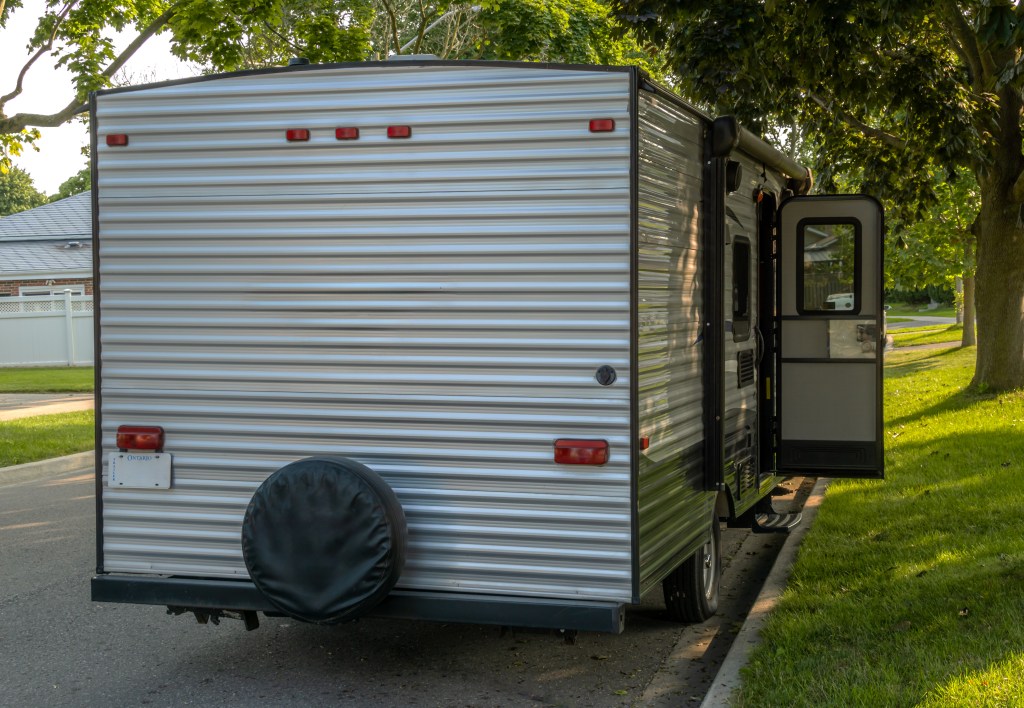 The campsite trailer parked on the road.